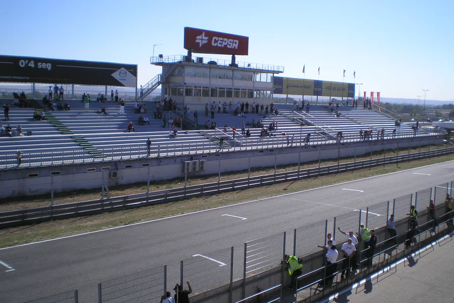 The pit straight at the Jarama circuit near Madrid, with the control tower and an empty concrete grandstand behind it